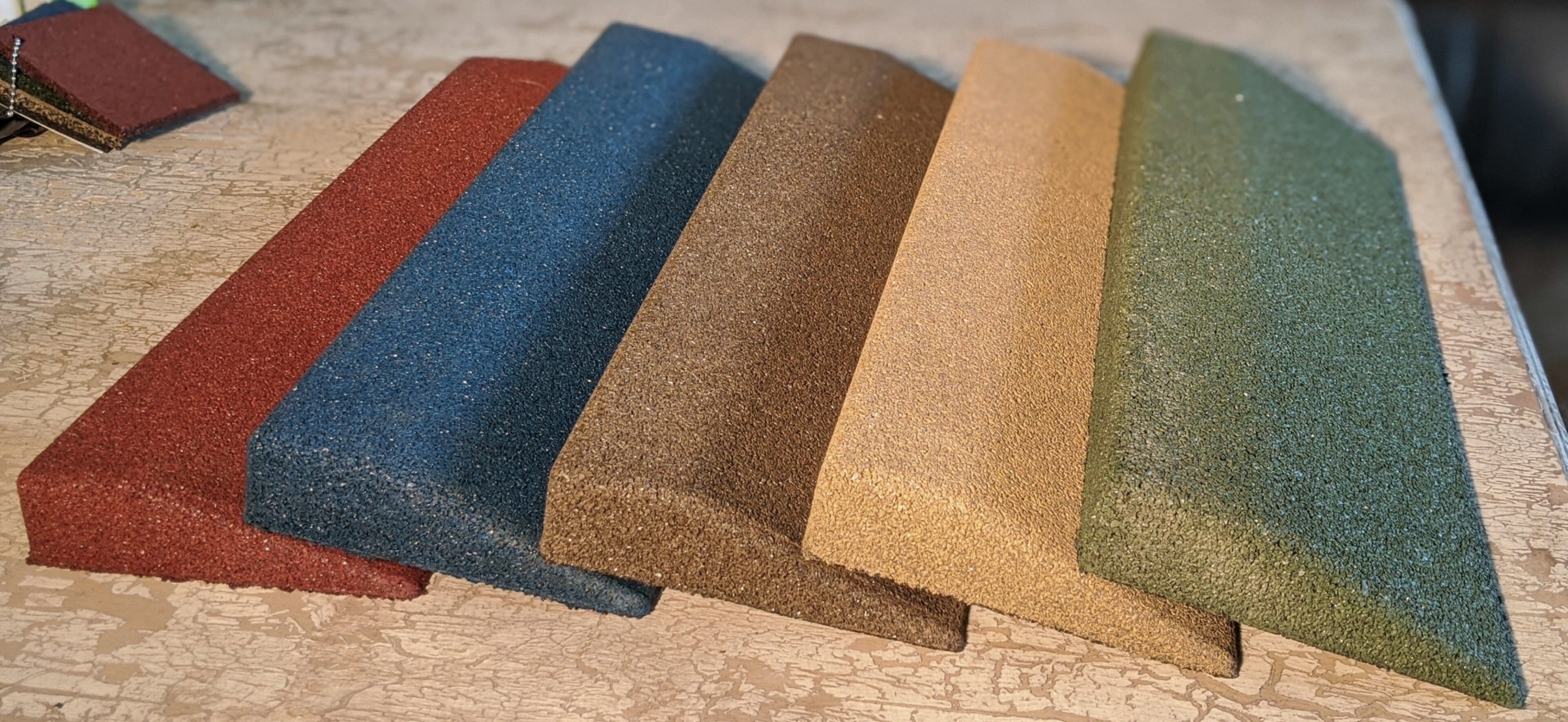 A group of different colored samples of carpet.