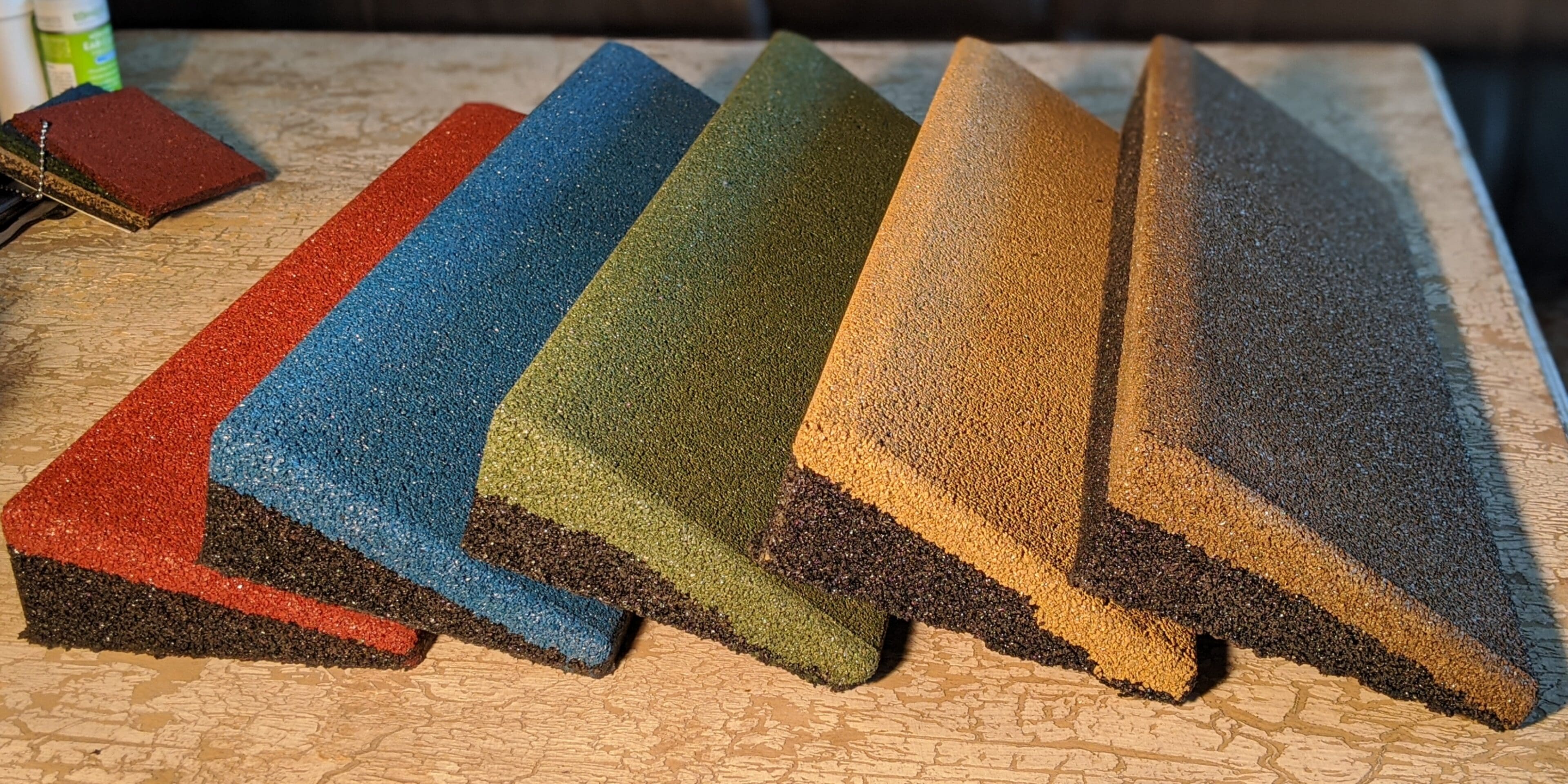 A group of different colored sponge on top of a table.