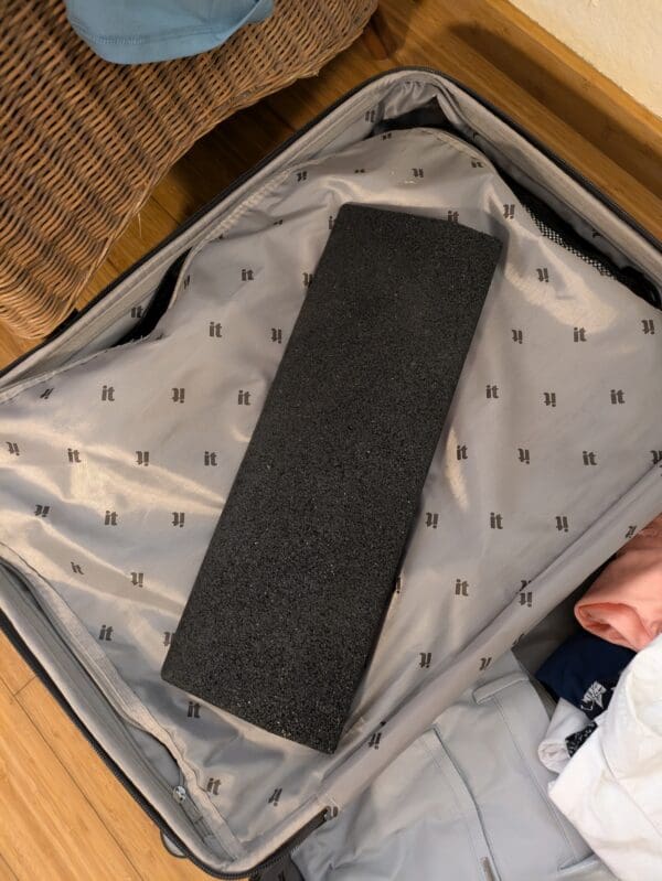 A piece of luggage with a black handle on it.