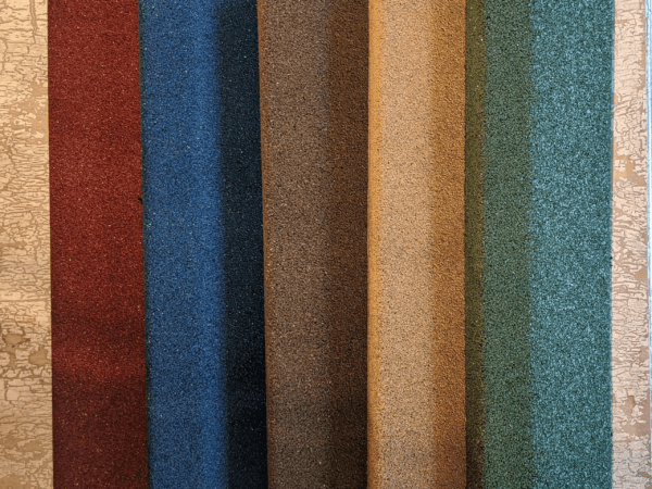 A close up of several different colored fabric